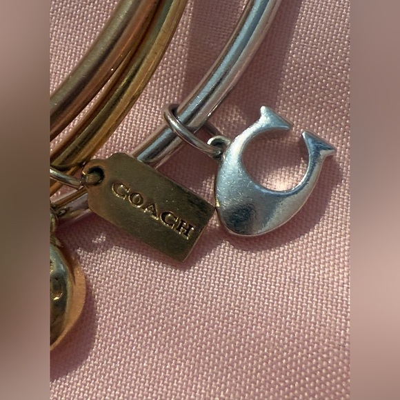 Coach 3 bangle bracelets 2 gold plated and 1 silver
All have dangly charms - Picture 3 of 5